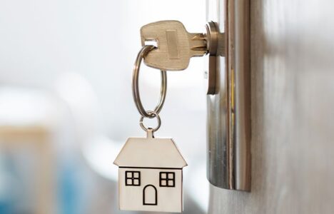 A key with house key chain on a door