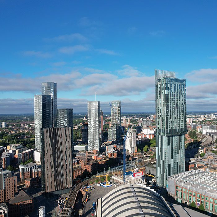 Manchester aerial view showing tall, modern buildings and blue sky
