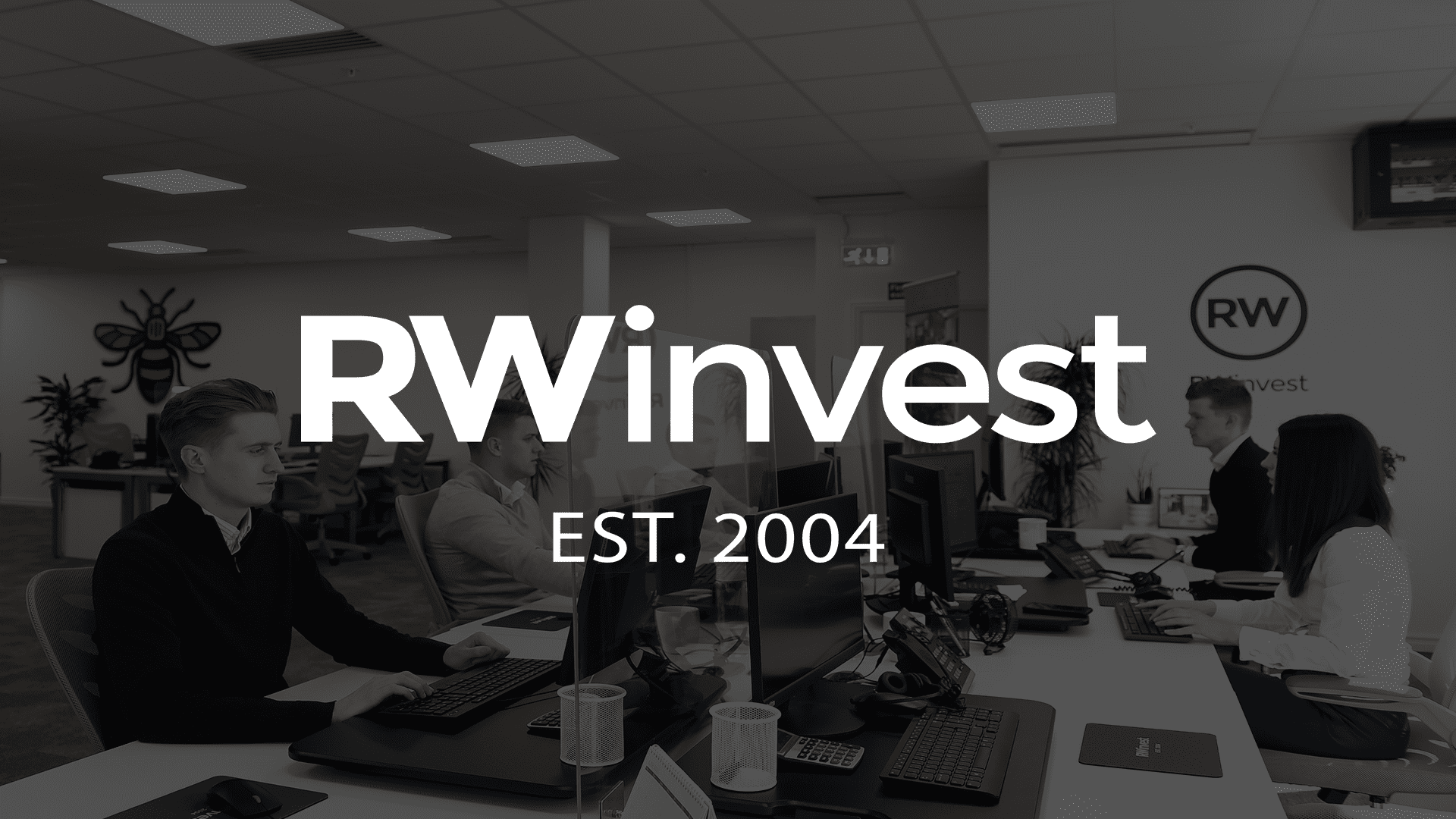 RWinvest logo imposed over office desks with employees working in a property investment company