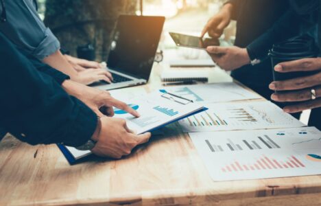 A group of property investors having meetings and with documents on their table looking at investment and market trends