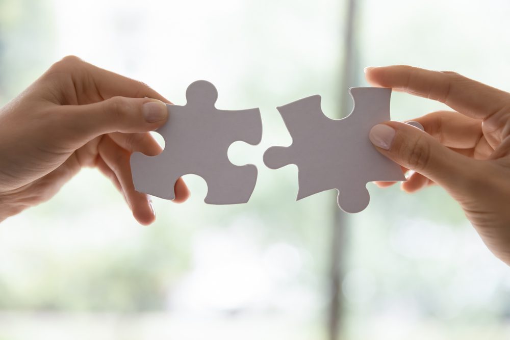 Two pieces of puzzle joining together