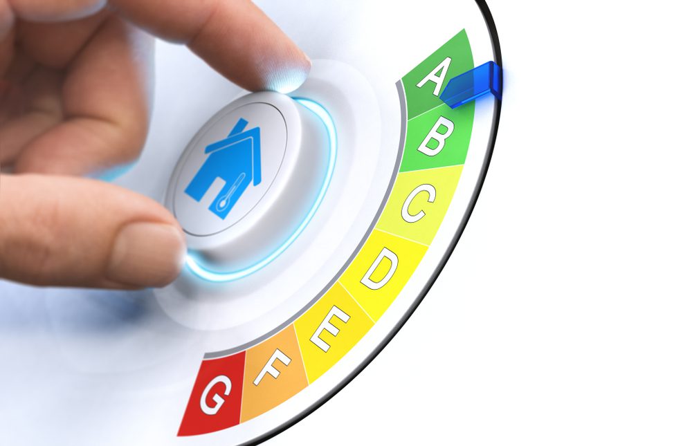 A hand turning a knob which indicates the rating of EPC