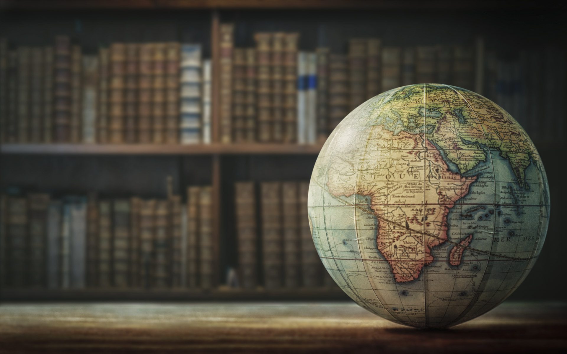 Old globe on bookshelf background. Selective focus. Retro style. Science, education, travel, vintage background. History team.