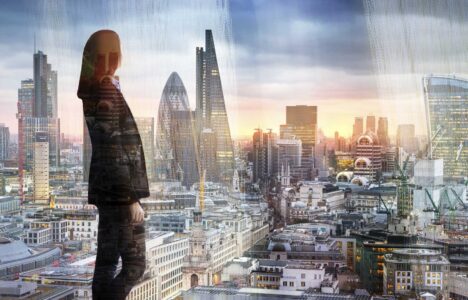 Young woman looking at the City of London, financial district. Early morning. Sun rise. Future, planning and business progress concept.