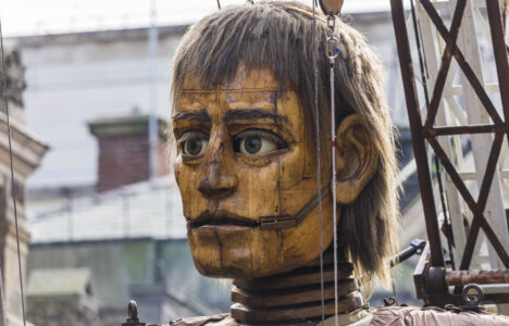 Giant man backlit by the sunshine in Liverpool.