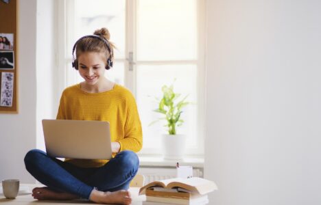Lady joyfully looking at her laptop
