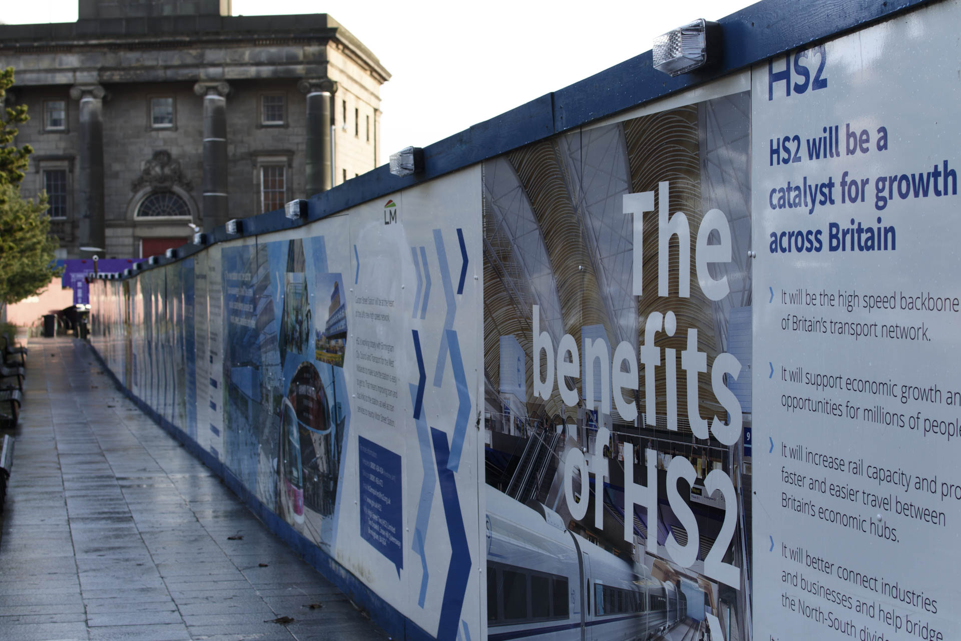 Hoarding in Birmingham advertising benefits of HS2 transport improvement in West Midlands cities