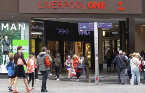 Shoppers entering Liverpool One shopping centre, an example of successful investment and regeneration in the UK city