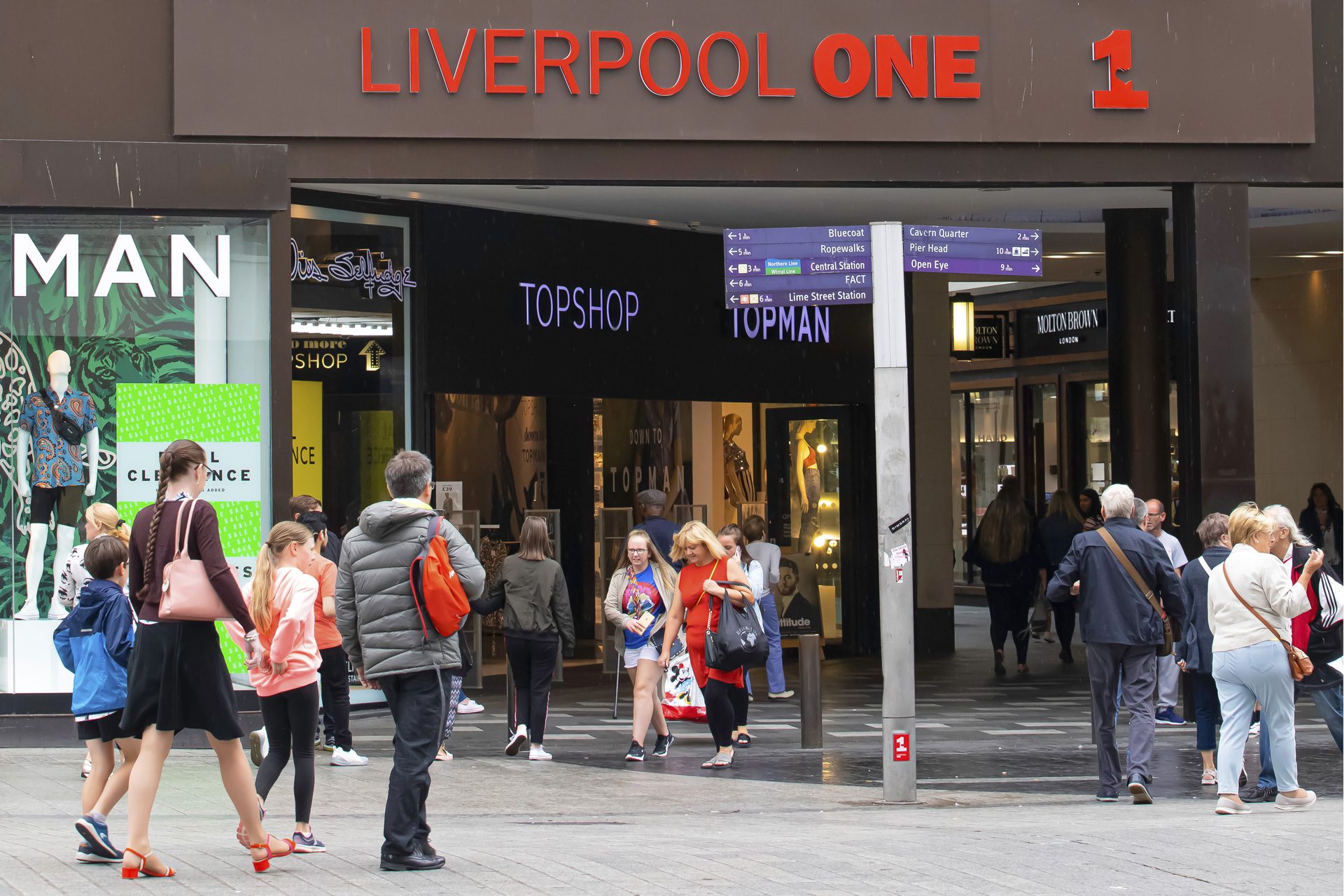 Shoppers entering Liverpool One shopping centre, an example of successful investment and regeneration in the UK city