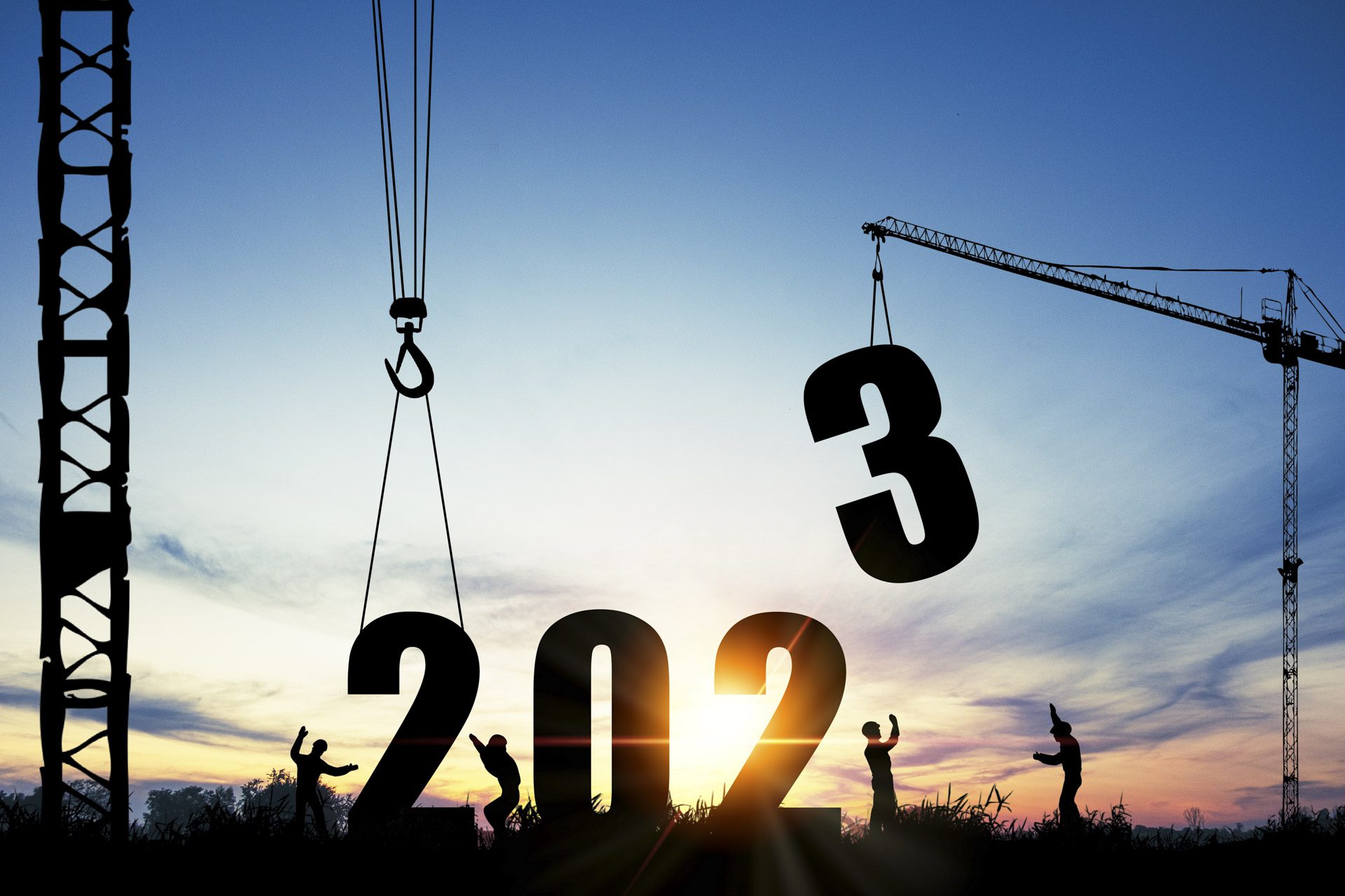 Construction workers with cranes arranging the numbers 2023 representing the new year property market