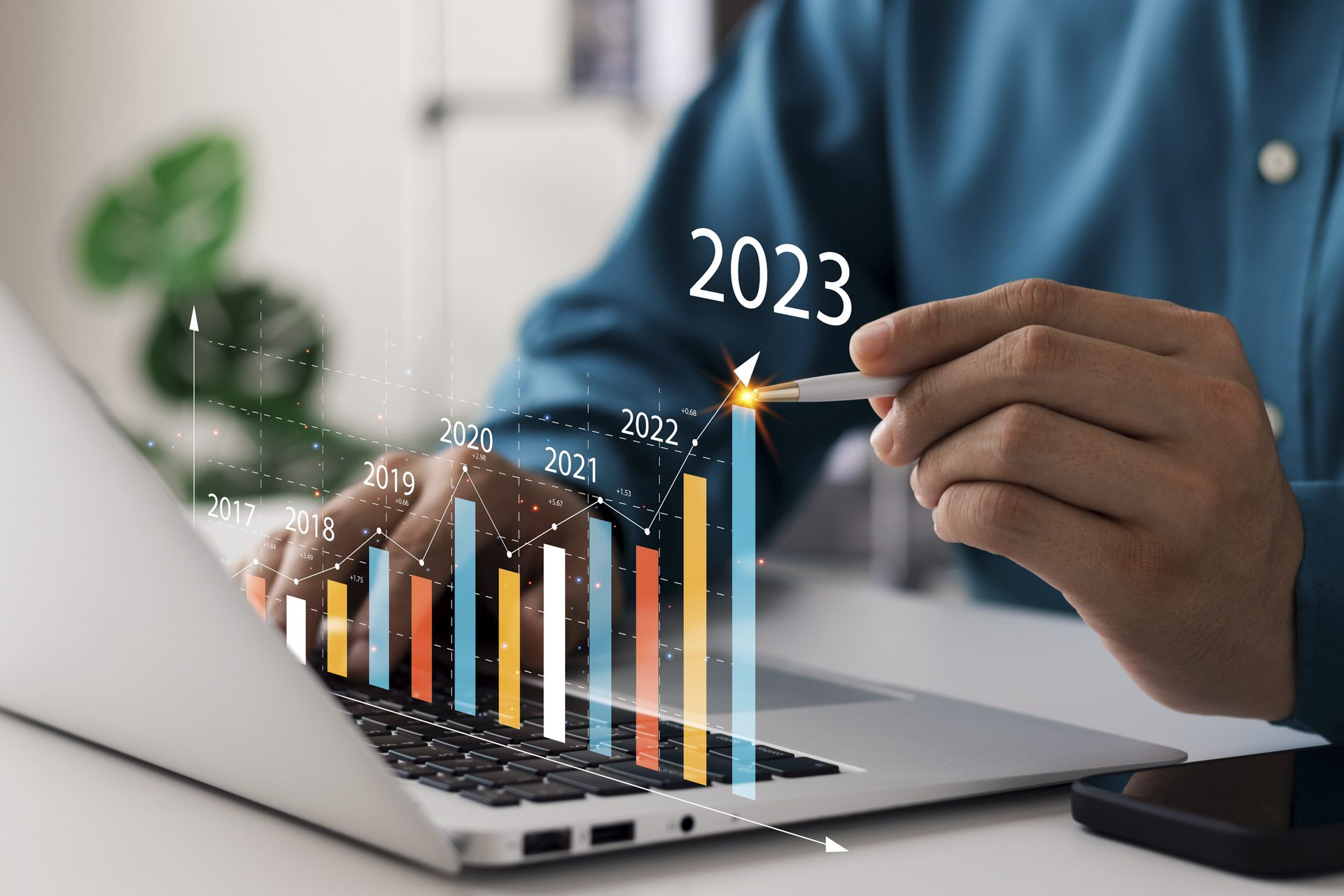 Businessman analyses profitability of property investment with digital augmented reality graphics showing growth in 2023