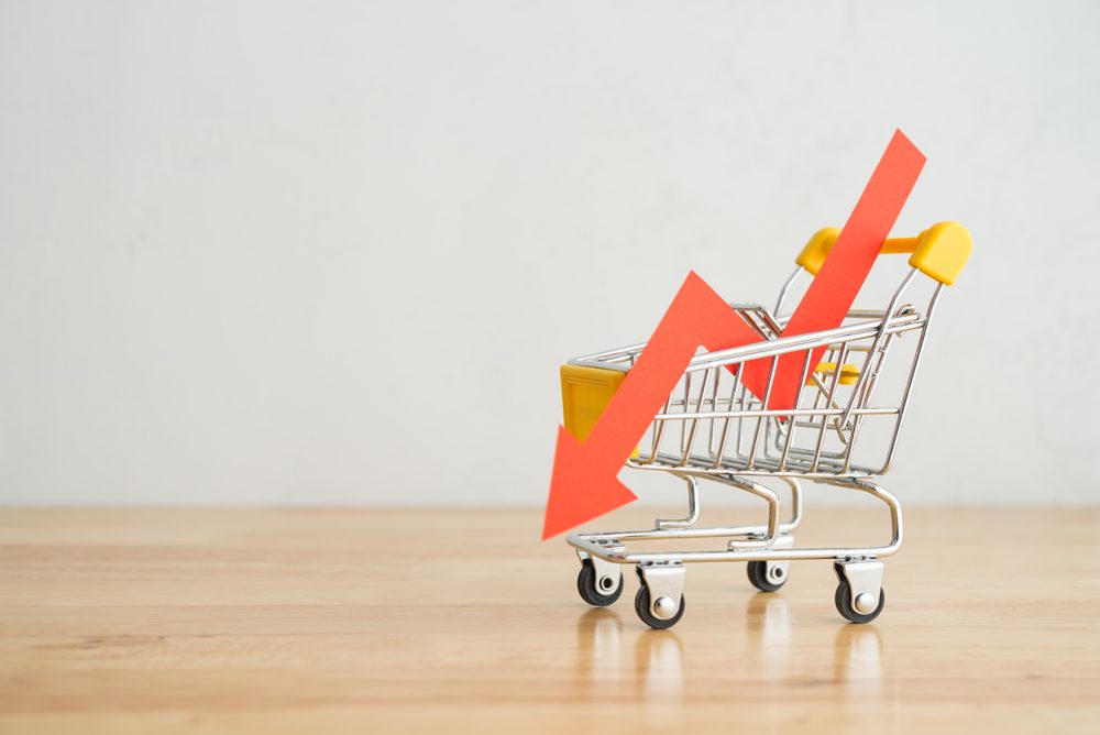 Shopping trolley with downward graph arrow representing falling prices in UK property market