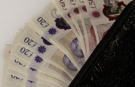 an open wallet with British pounds peeking out