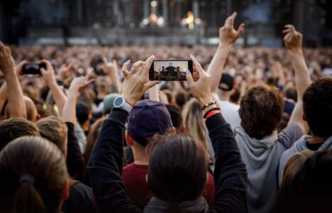 Smartphone in the hand of a music fan at the summer concert
