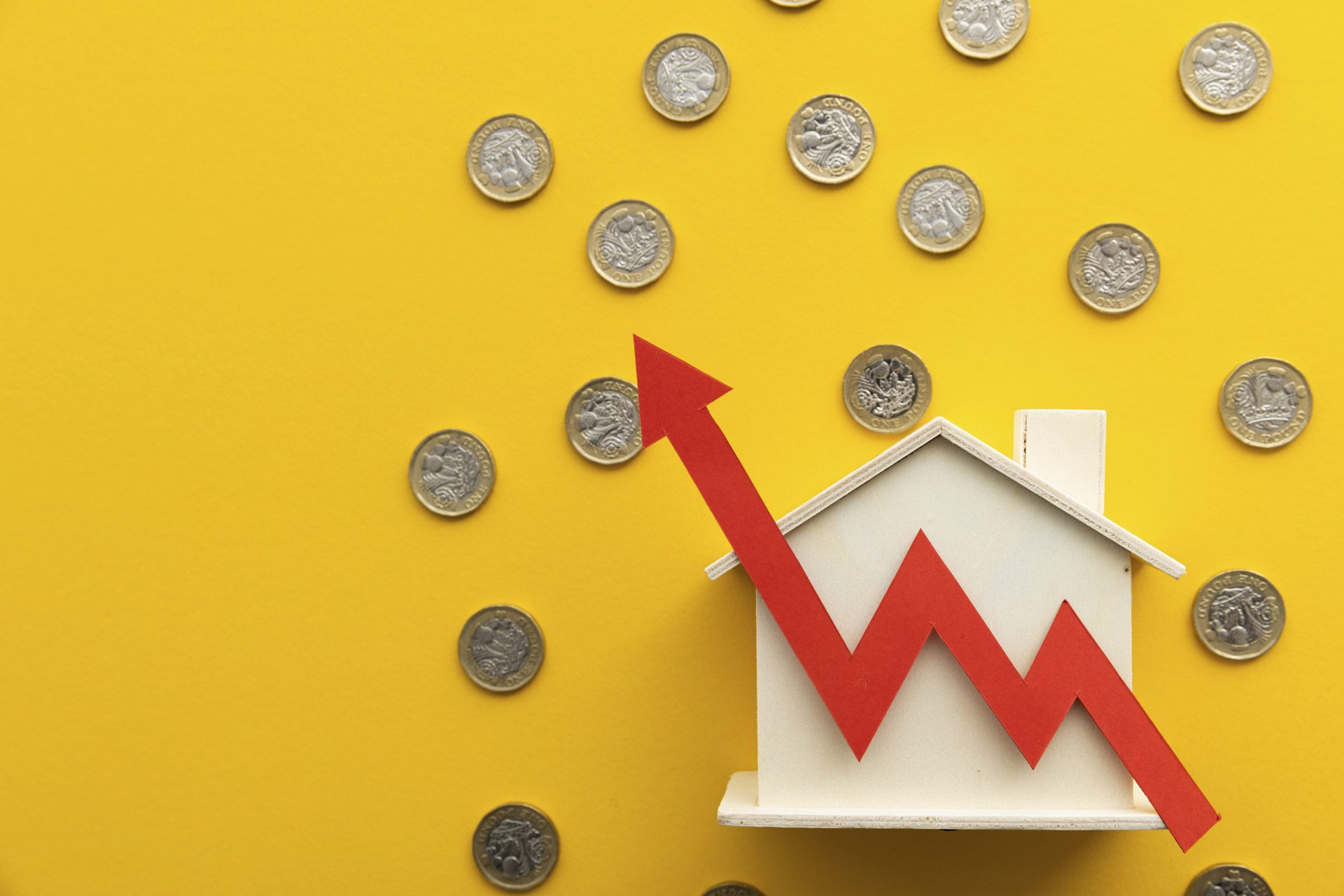 Upward graph over house and pound coins representing increased tenant demand in UK housing market