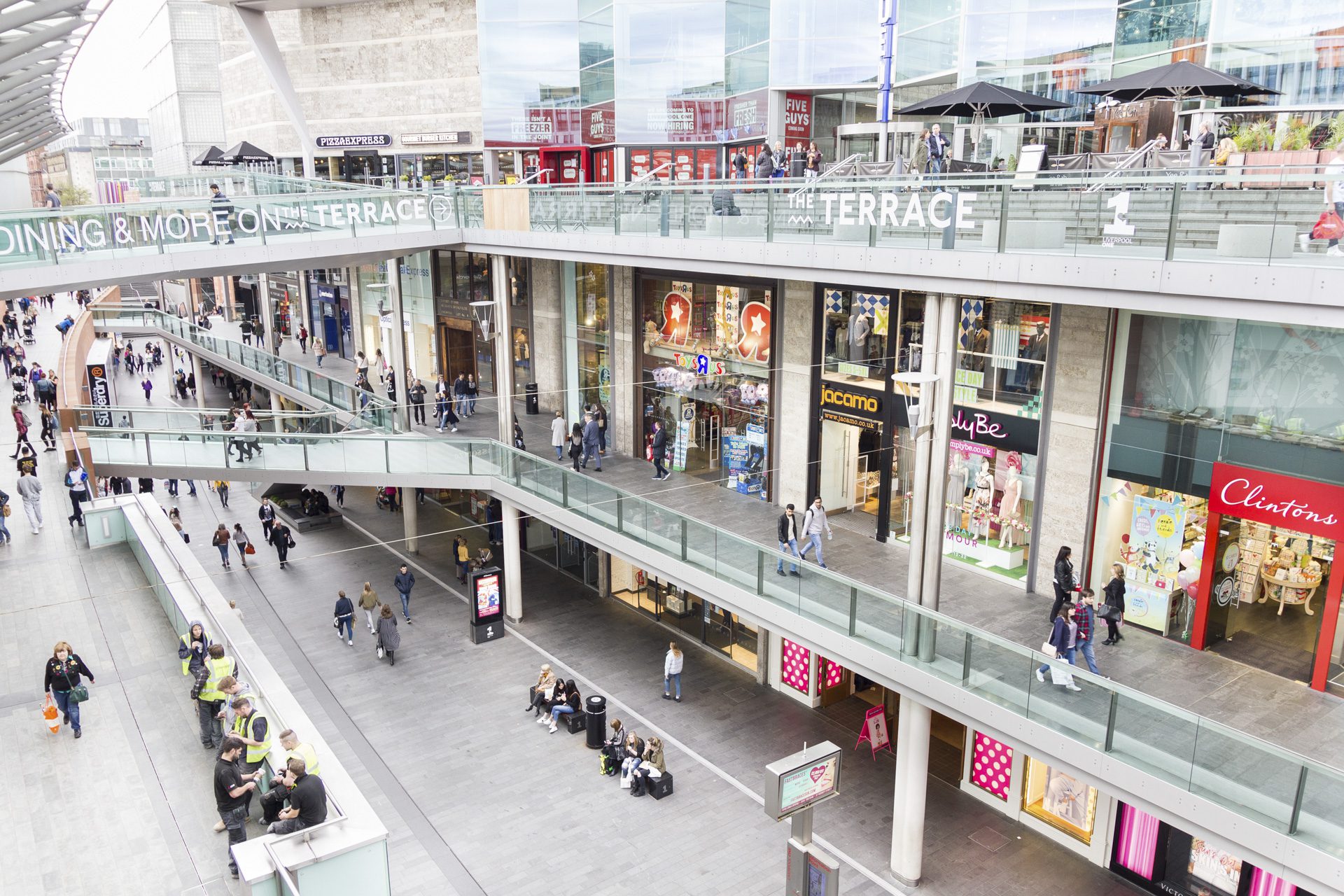 LIVERPOOL, ENGLAND - APRIL 3, 2017: People walking in the Liverpool One shopping centre. The place is the largest open air shopping centre in the United Kingdom and the 5th largest overall.