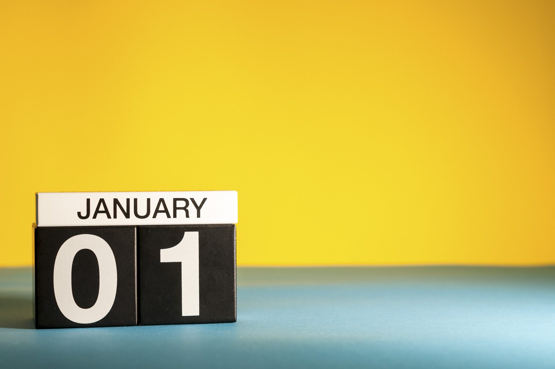 January 1st. Day 1 of january month, calendar on yellow background. Winter time. Empty space for text