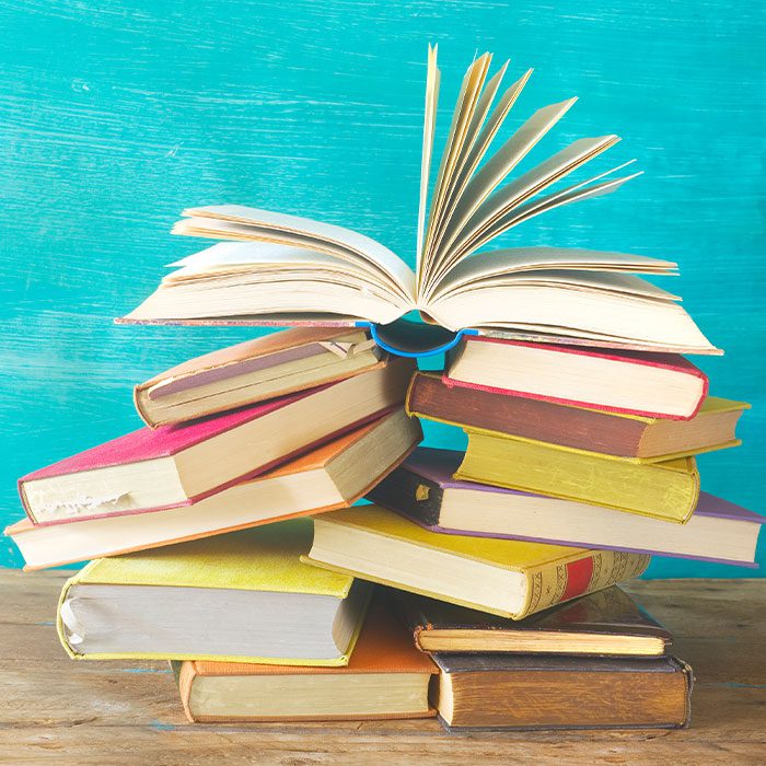 Flipping book on top of other books