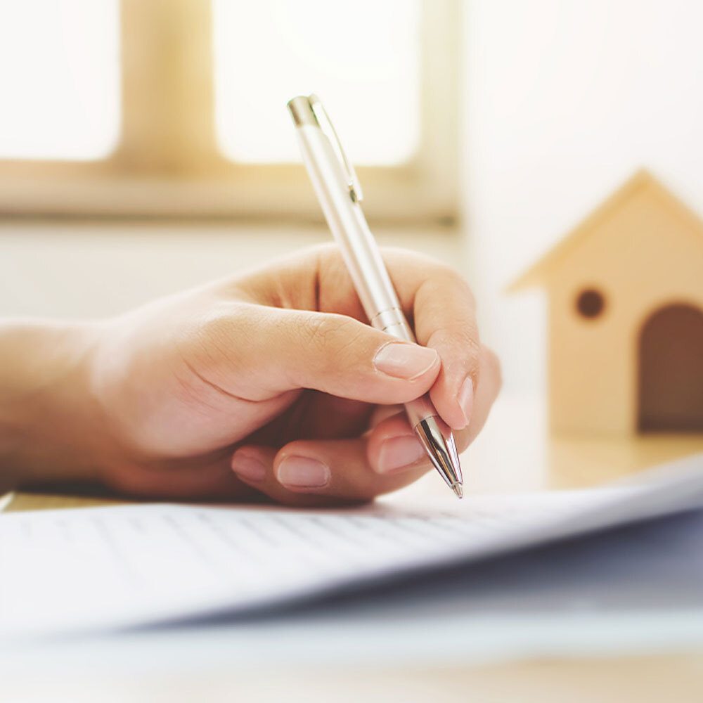 Property investor's hand signing a contract when making an investment