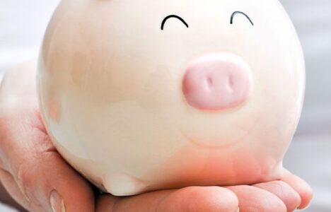Hand holding a piggy saving