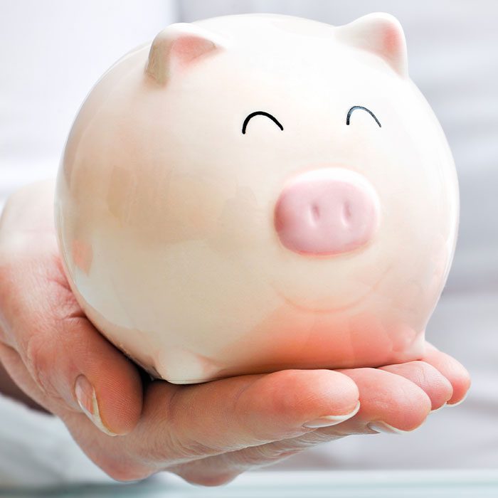 Hand holding a piggy saving