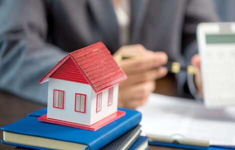 House model on a stack of notebooks