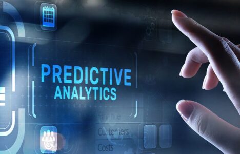 Hand pointing at hologram with 'predictive analytics'