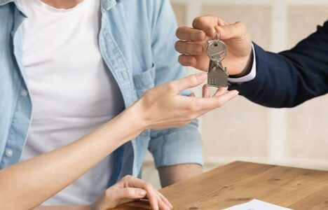 Landlord handing keys to the tenant after signing contract for a short term let