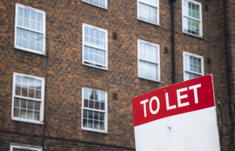 To Let sign with council housing flats in the background in south London