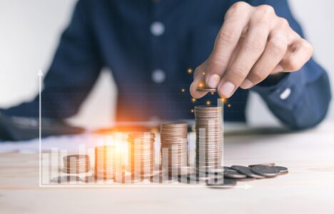 Property investor stacking coins to represent a high rental yield