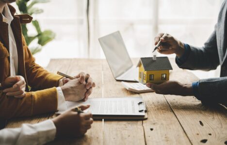 Property investors discussing a real estate opportunity with an agent about to sign a contract