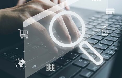 A person typing on the keyboard with hologram displaying