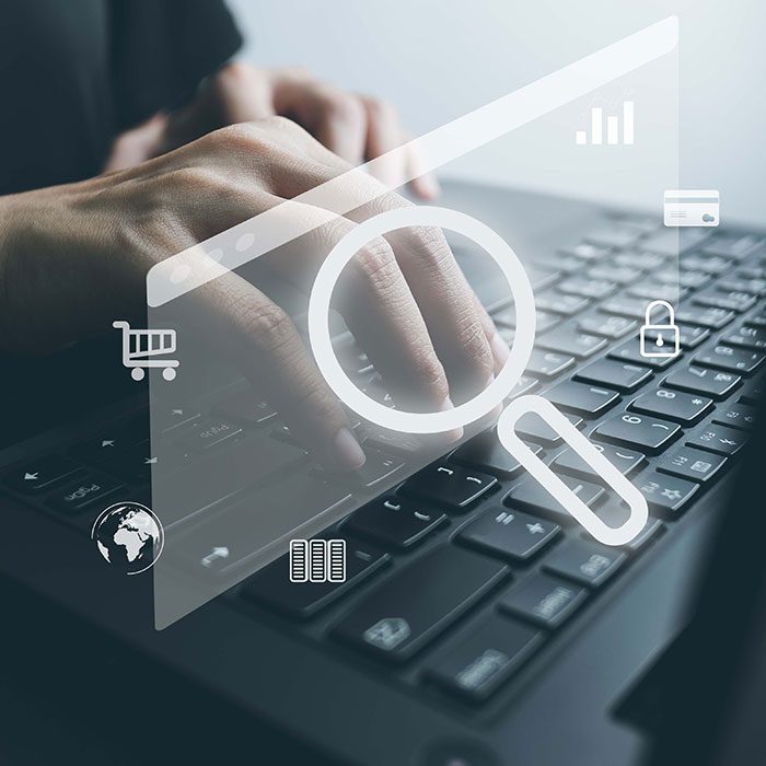 A person typing on the keyboard with hologram displaying
