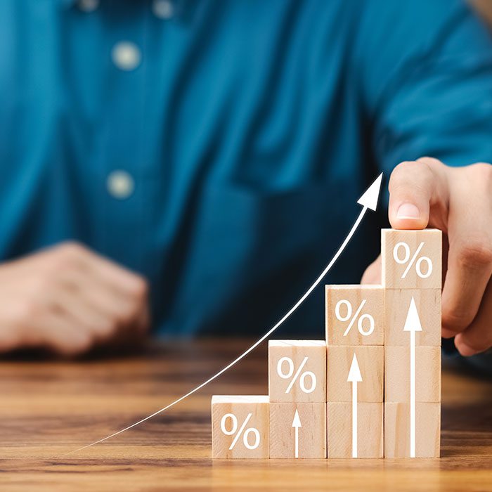 Person pointing at stacks of blocks representing a rise in statistics