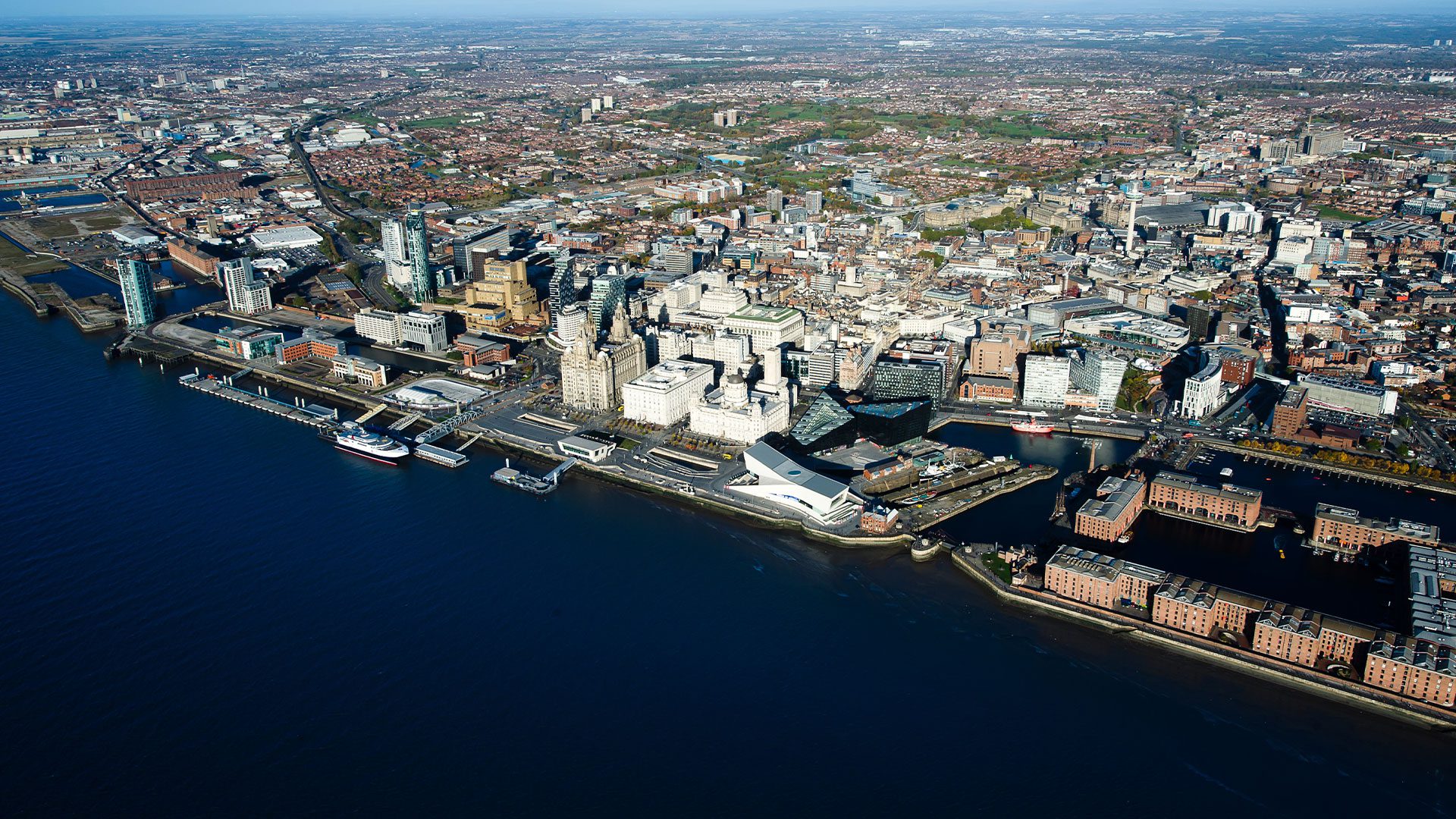 Aerial daytime view of Liverpool and River Mersey showing various areas of the city