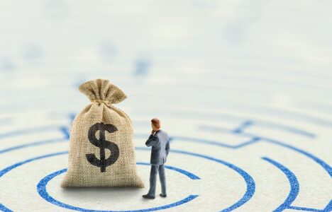 Person stands in front of a bag of money after solving the puzzle