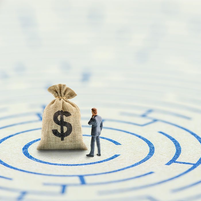 Person stands in front of a bag of money after solving the puzzle