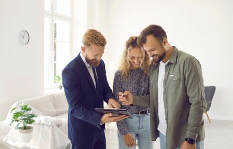 Couple signing up rental contract for property with the estate agent