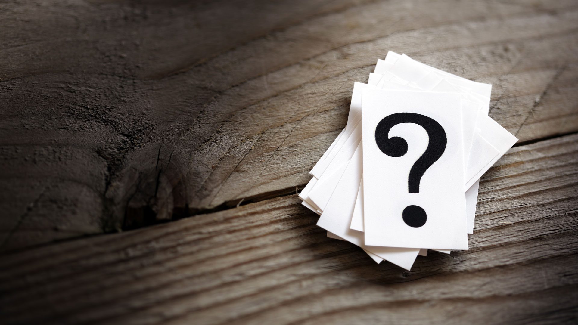 Stack of cards with a question mark printed on,