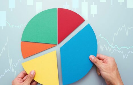 Hands holding pieces of a pie chart