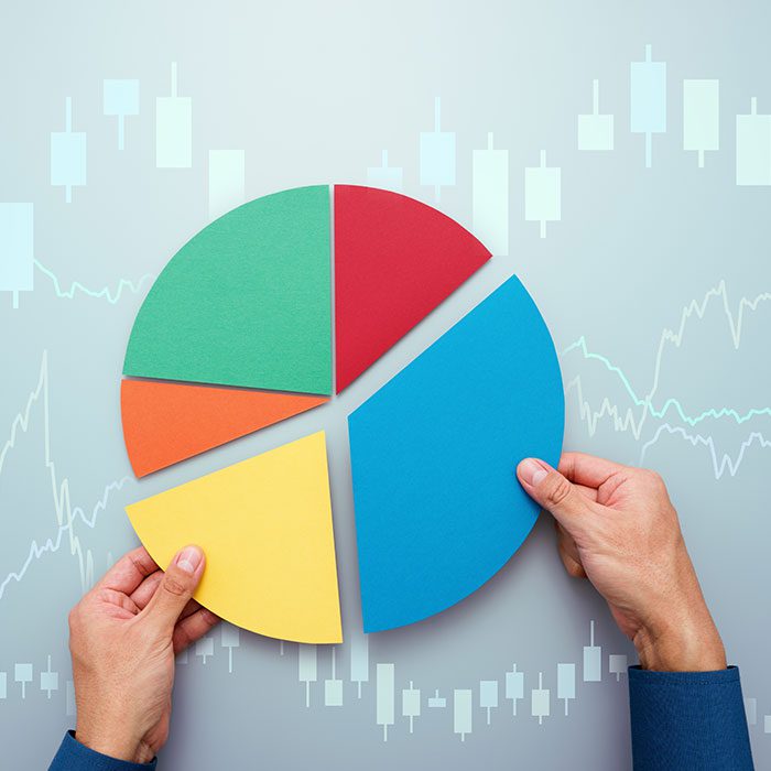 Hands holding pieces of a pie chart