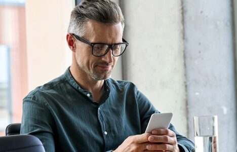 A person looking at his phone for more property information