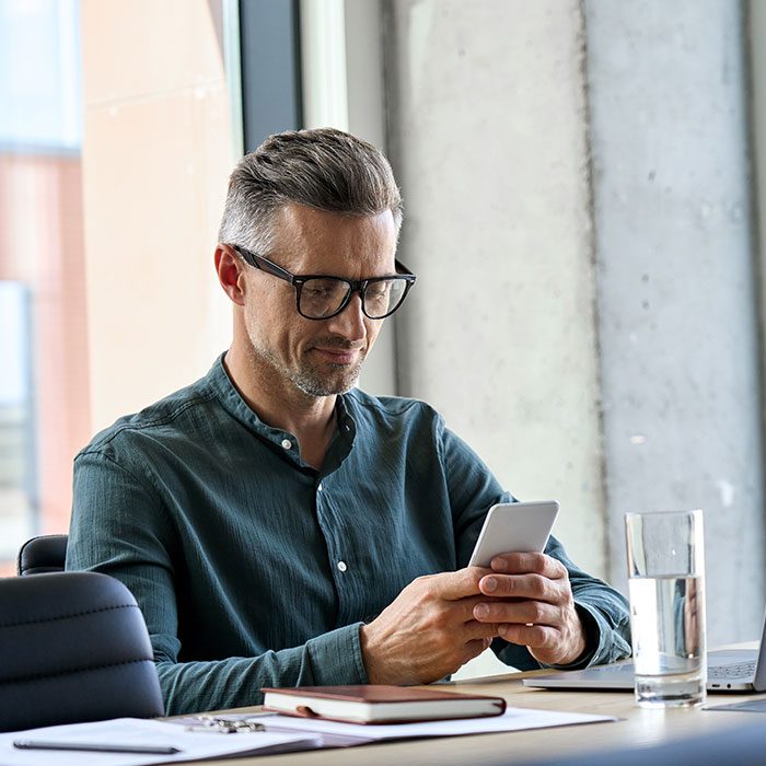 A person looking at his phone for more property information