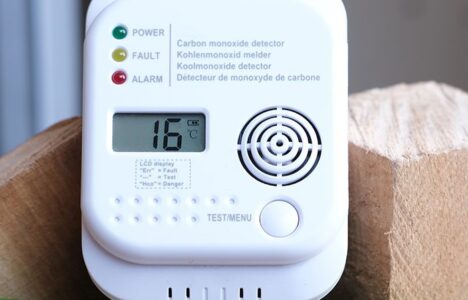 Carbon monoxide detector on a bucket of wood logs