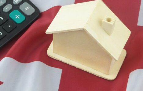 House model and calculator on a UK Flag