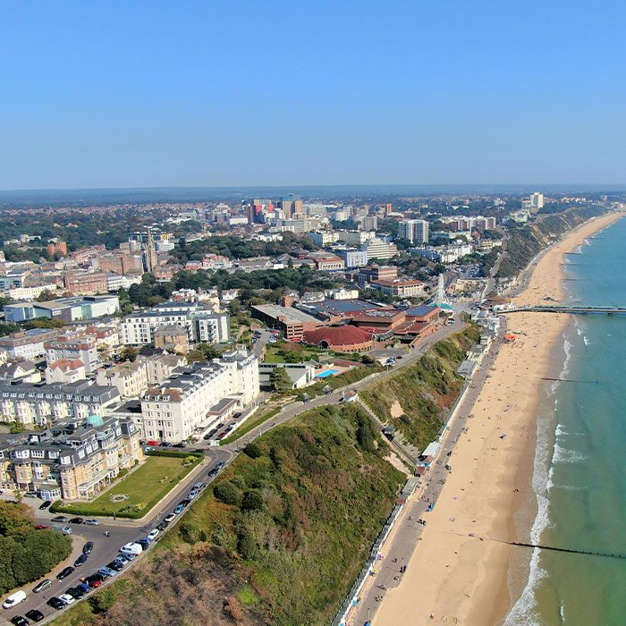 Aerial view of Bournemouth's coastline during the day, showing beach and waterfront properties