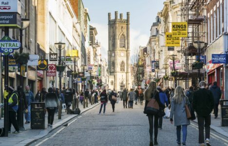 View up Bold Street in Liverpool City Centre during the day with shoppers in foreground and St Luke's church in the distance