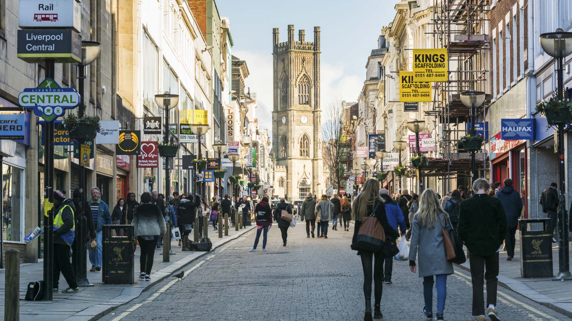 View up Bold Street in Liverpool City Centre during the day with shoppers in foreground and St Luke's church in the distance