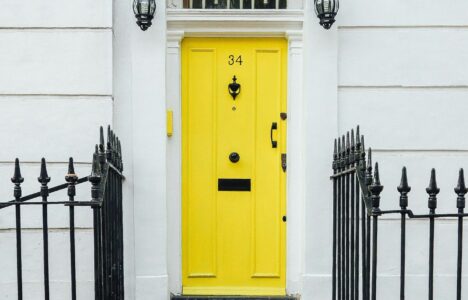 house with railings and a yellow door