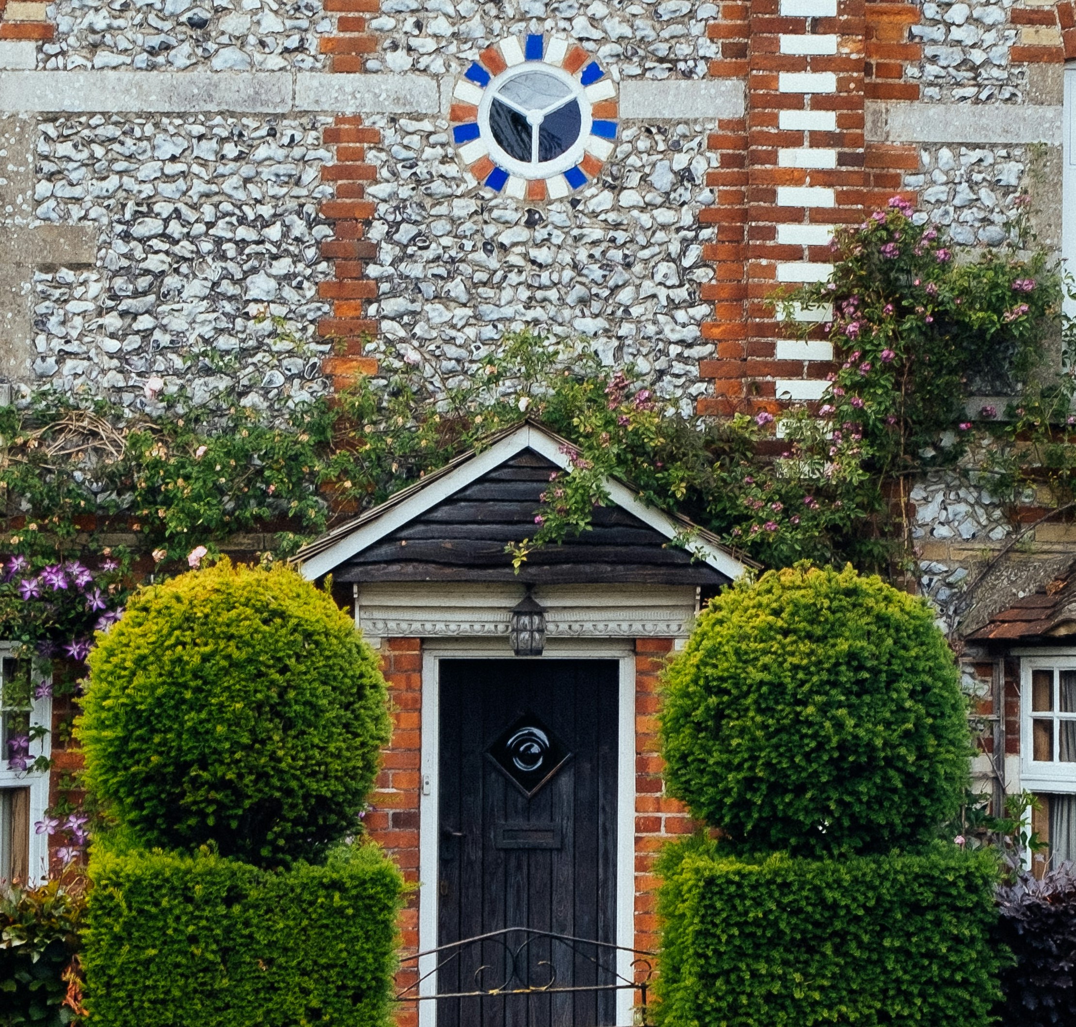 house with a front door and decorative lawn hedges